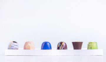 Cocoa Dolce’s handcrafted Easter chocolates, featuring luxury truffles and macarons styled in an elegant pastel-themed setting