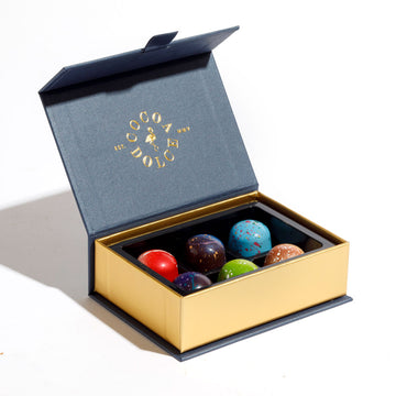 Assorted dessert inspired chocolates including raspberry, cheesecake and fruit flavors