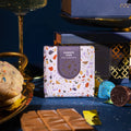 Gold chocolate confetti cake bar styled with colorful sprinkles for celebration
