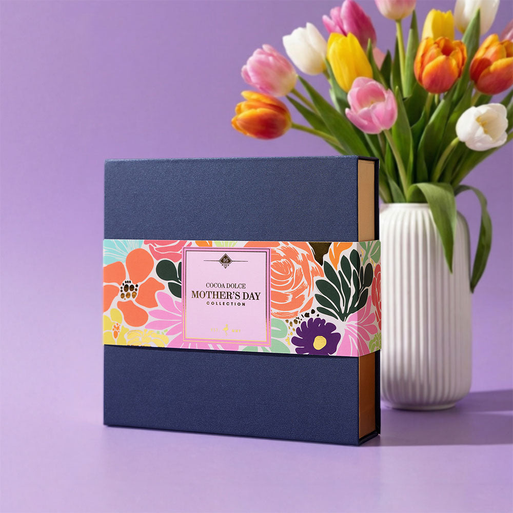 Mother’s Day chocolate assortment displayed with spring flowers, featuring handcrafted Belgian chocolate truffles