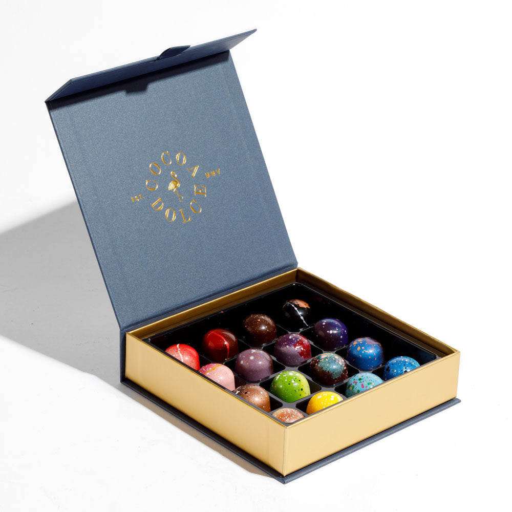 Mother’s Day chocolate assortment displayed with spring flowers, featuring handcrafted Belgian chocolate truffles